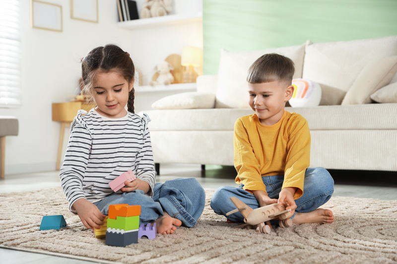 children playing with blocks on the floor happily